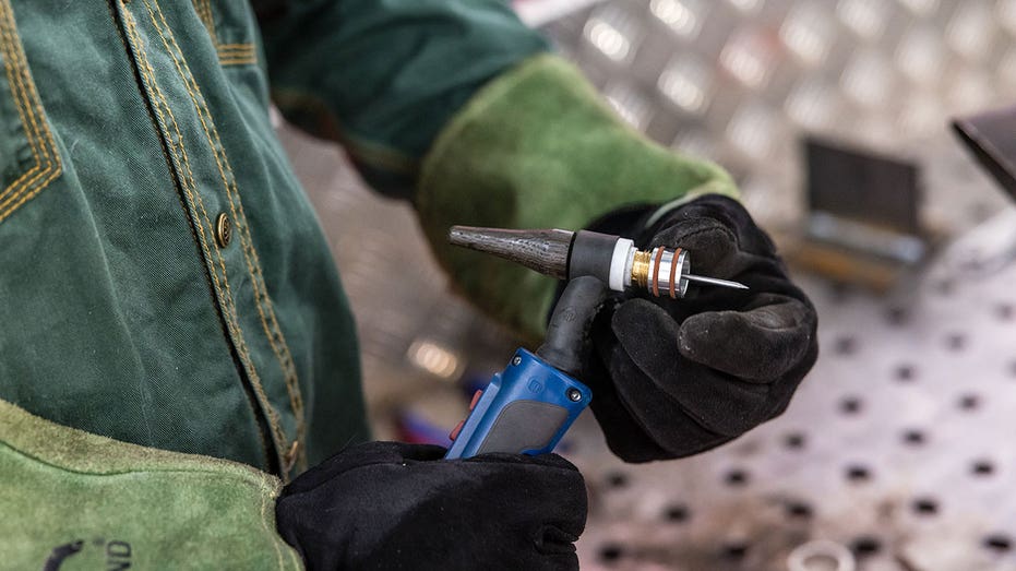 A man assembling a torch for his welding job