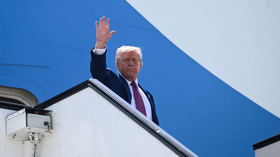 TOPSHOT - US President Donald Trump waves farewell as he boards Air Force One to his next stop, at the end of the Qatari leg of his regional tour at the Al-Udeid air base southwest of Doha on May 15, 2025. (Photo by Brendan SMIALOWSKI / AFP) (Photo by BRENDAN SMIALOWSKI/AFP via Getty Images)