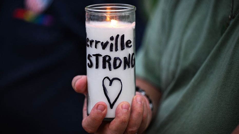 A person holds a candle reading "Kerrville strong" during a vigil for the victims of the floods over Fourth of July weekend, at Travis Park, in San Antonio, Texas, on July 7, 2025. The death toll from catastrophic flooding in Texas rose to more than 100 on July 7, as rescuers continued their grim search for people swept away by torrents of water. Among the dead were at least 27 girls and counselors who were staying at a youth summer camp on a river when disaster struck over the Fourth of July holiday weekend. (Photo by RONALDO SCHEMIDT / AFP) (Photo by RONALDO SCHEMIDT/AFP via Getty Images)