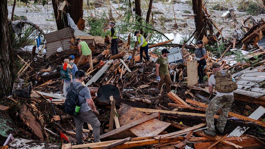 HUNT, TEXAS - JULY 6: Search and rescue workers dig through debris looking for any survivors or remains of people swept up in the flash flooding on July 6, 2025 in Hunt, Texas. Heavy rainfall caused flooding along the Guadalupe River in central Texas with multiple fatalities reported. (Photo by Jim Vondruska/Getty Images)