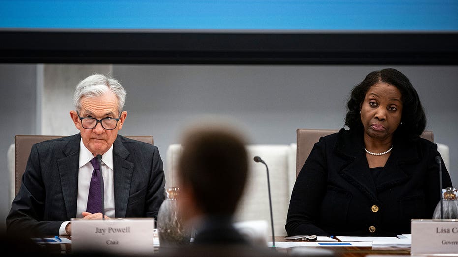 Jerome Powell and Lisa Cook sitting at a table