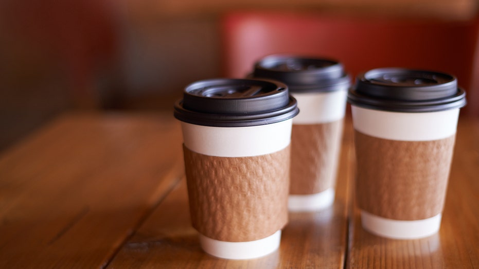 Three Coffee cups sitting on brown table