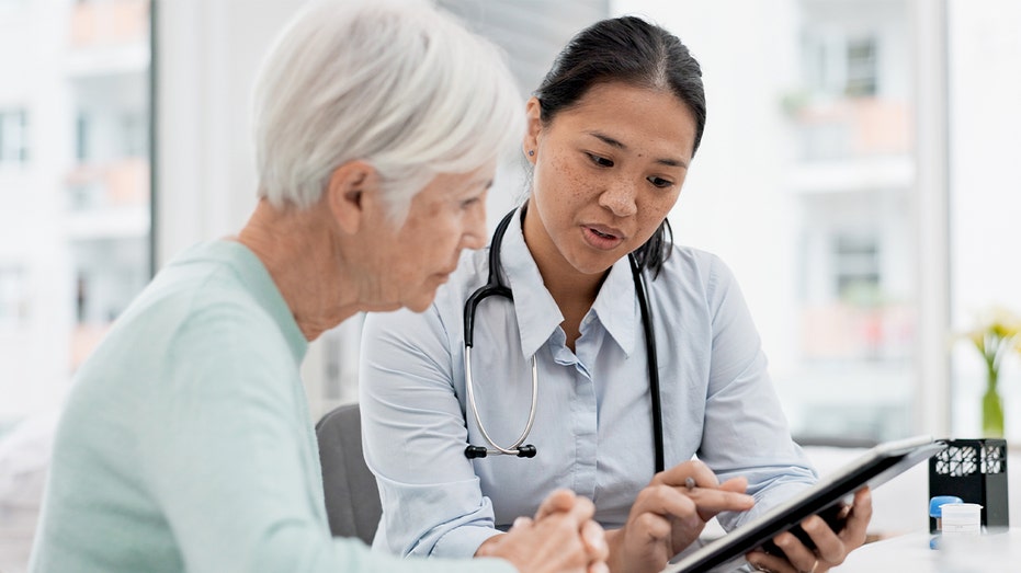 A doctor speaks with an elderly patient