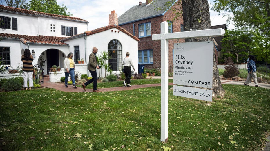 People exit an open house at a home for sale.