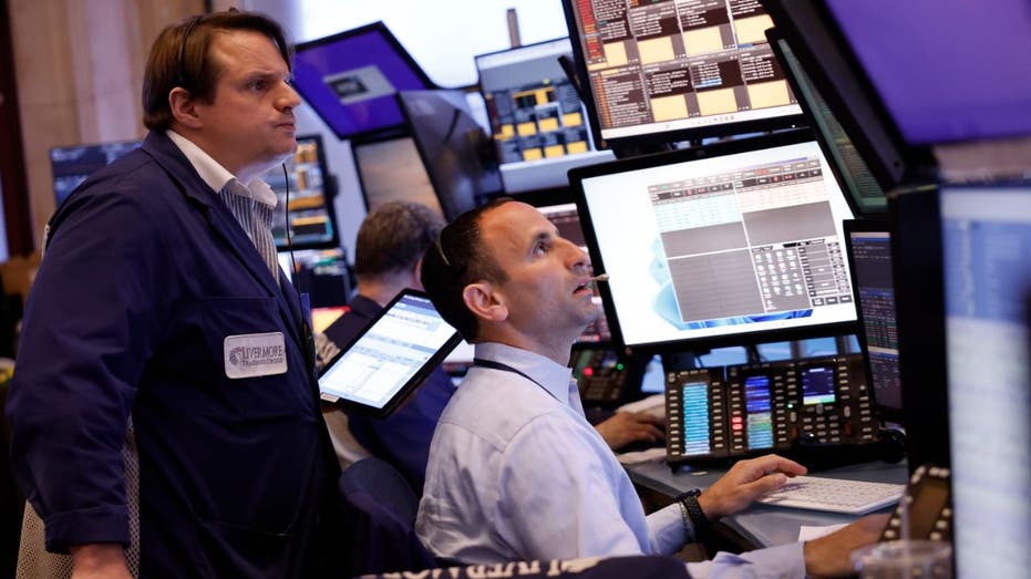 Traders at the NYSE in lower Manhattan monitoring a volatile trading day.