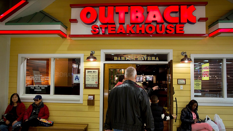 Customers enter an Outback Steakhouse
