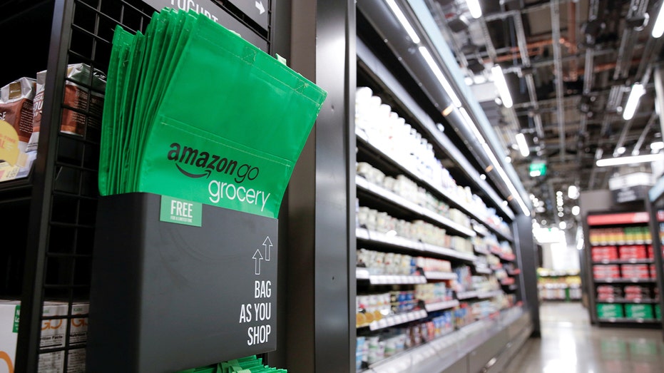 A branded Amazon Go shopping bag inside a cashierless grocery store environment.