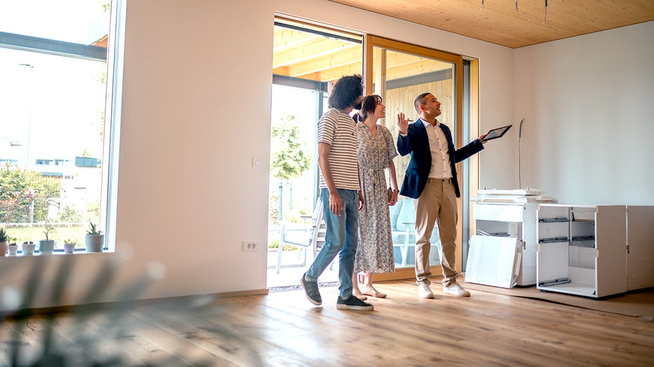 Real estate agent and a couple.